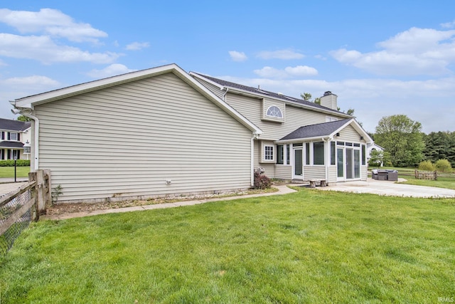 51178 Ashley Dr, Granger, IN 46530 - back of property with a sunroom, a chimney, and a patio