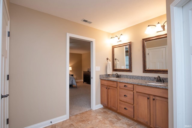 6118 Mackenzie Ct, West Lafayette, IN 47906 - ensuite bathroom featuring double vanity and baseboards