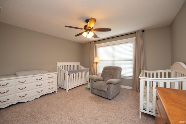 6118 Mackenzie Ct, West Lafayette, IN 47906 - bedroom with light carpet, a nursery area, a ceiling fan, and baseboards