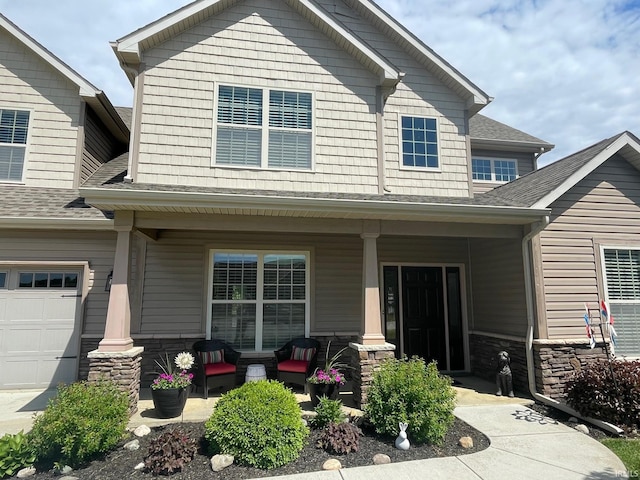 6118 Mackenzie Ct, West Lafayette, IN 47906 - view of front of house featuring covered porch, stone siding, and roof with shingles