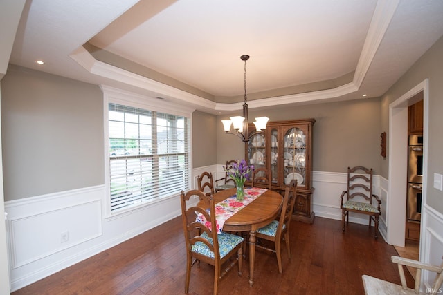 6118 Mackenzie Ct, West Lafayette, IN 47906 - dining space with a raised ceiling, wainscoting, a chandelier, dark wood-type flooring, and a decorative wall