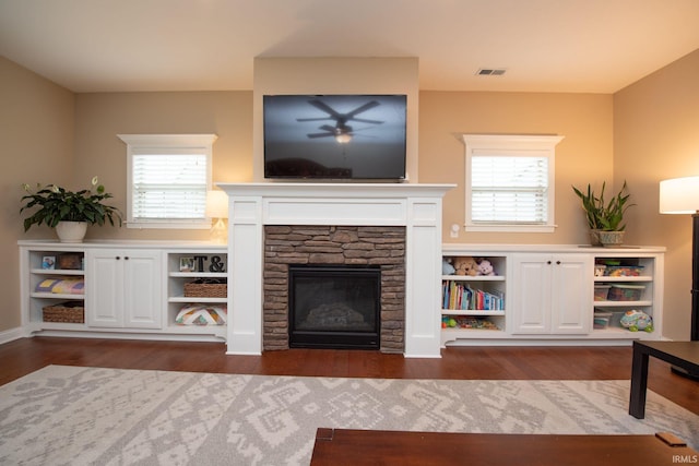 6118 Mackenzie Ct, West Lafayette, IN 47906 - living room featuring ceiling fan, healthy amount of natural light, a stone fireplace, and dark wood-style floors