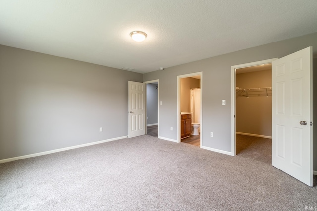 3827 Winter Raven Trl, Fort Wayne, IN 46818 - unfurnished bedroom with carpet floors, a spacious closet, baseboards, a closet, and ensuite bathroom