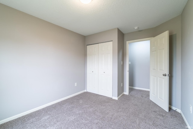 3827 Winter Raven Trl, Fort Wayne, IN 46818 - unfurnished bedroom with carpet floors, a closet, baseboards, and a textured ceiling