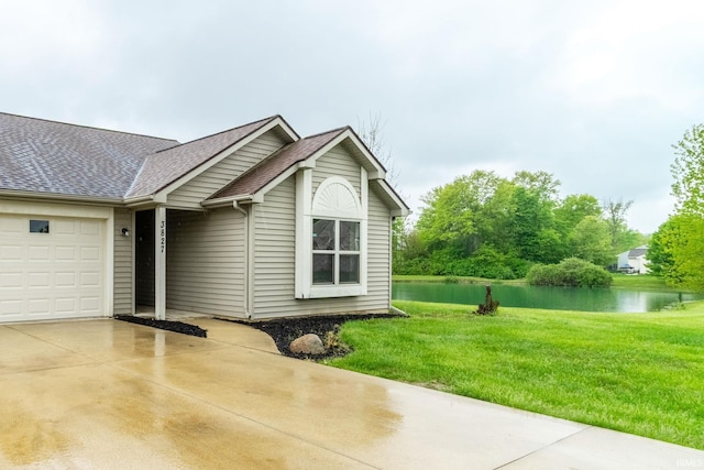 3827 Winter Raven Trl, Fort Wayne, IN 46818 - view of front of home with a water view, a garage, driveway, roof with shingles, and a front yard