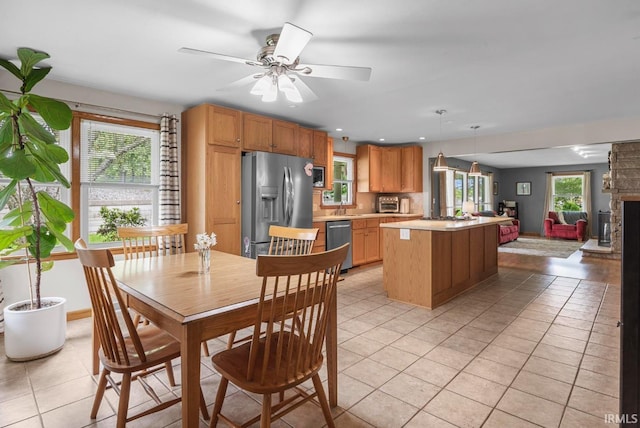 1437 W State Road 56th Rd, Jasper, IN 47546 - kitchen with stainless steel appliances, light tile patterned flooring, light countertops, a kitchen island, and open floor plan