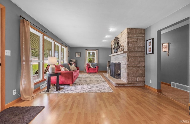 1437 W State Road 56th Rd, Jasper, IN 47546 - living area featuring a stone fireplace, wood finished floors, and baseboards