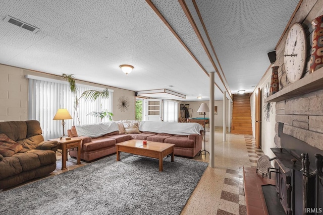 1437 W State Road 56th Rd, Jasper, IN 47546 - living area featuring speckle patterned floor, a fireplace, and concrete block wall