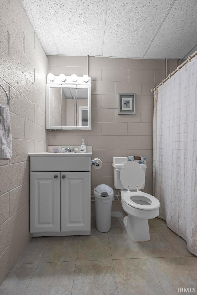 1437 W State Road 56th Rd, Jasper, IN 47546 - bathroom with toilet, vanity, a drop ceiling, and concrete block wall