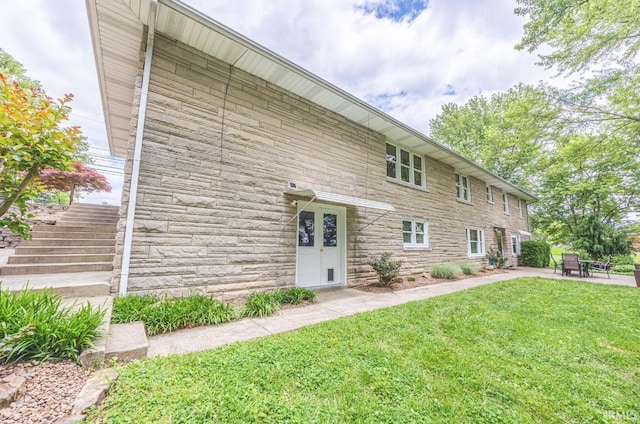 1437 W State Road 56th Rd, Jasper, IN 47546 - view of front of house with stone siding, a front yard, a patio, and stairway