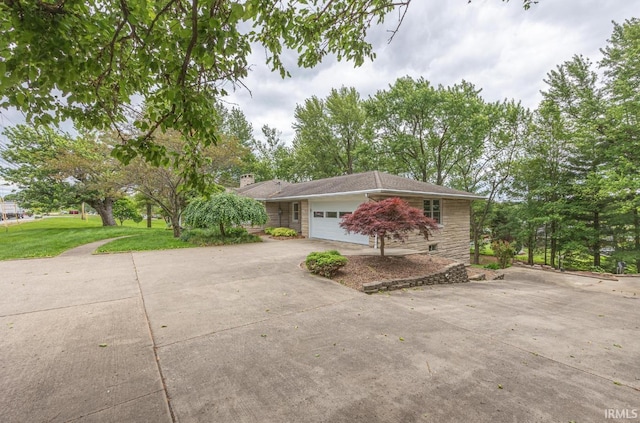 1437 W State Road 56th Rd, Jasper, IN 47546 - view of front of home with concrete driveway, an attached garage, a front lawn, a chimney, and stone siding