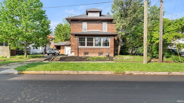 524 Byron St, Huntington, IN 46750 - american foursquare style home with brick siding, a front yard, and a garage