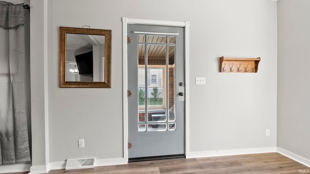 524 Byron St, Huntington, IN 46750 - foyer entrance featuring baseboards and wood finished floors