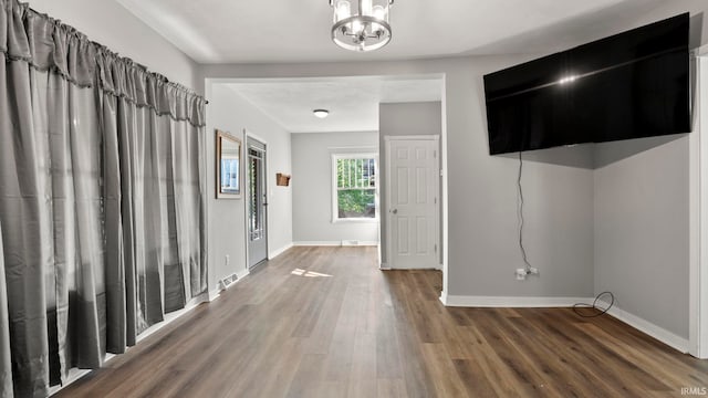 524 Byron St, Huntington, IN 46750 - foyer entrance featuring a chandelier, wood finished floors, and baseboards
