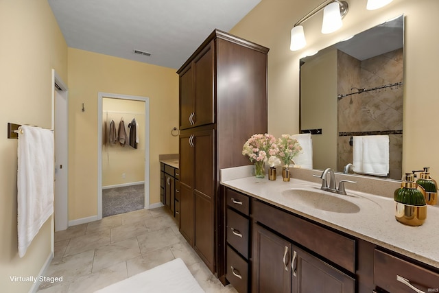 4300 Lithophone Ct, West Lafayette, IN 47906 - bathroom with vanity, tiled shower, and baseboards