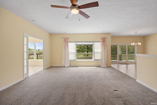 4300 Lithophone Ct, West Lafayette, IN 47906 - carpeted spare room with tile patterned flooring, a chandelier, a textured ceiling, a ceiling fan, and baseboards