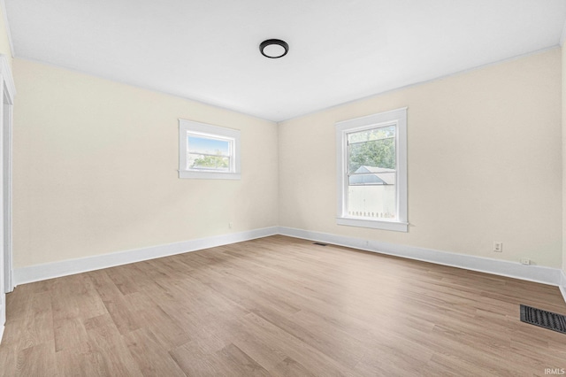 110 N Sheridan St, Kendallville, IN 46755 - spare room with wood finished floors, healthy amount of natural light, and baseboards