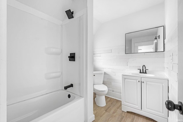 110 N Sheridan St, Kendallville, IN 46755 - bathroom with toilet, vanity, shower / tub combination, and wood finished floors