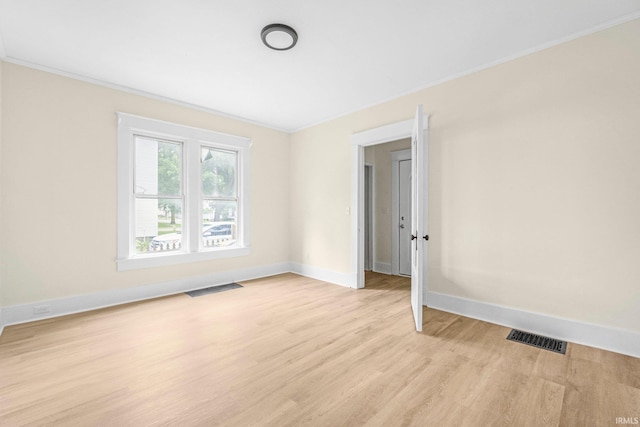 110 N Sheridan St, Kendallville, IN 46755 - spare room featuring crown molding, light wood-type flooring, and baseboards