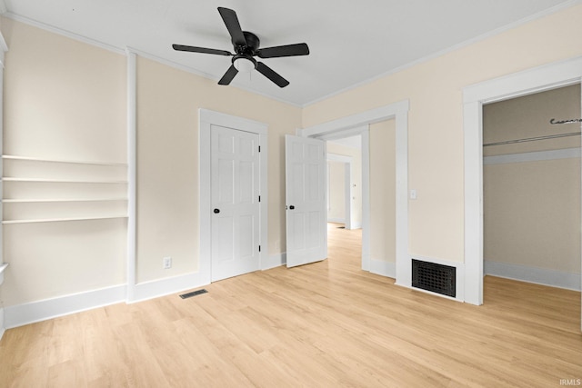 110 N Sheridan St, Kendallville, IN 46755 - unfurnished bedroom featuring crown molding, wood finished floors, baseboards, two closets, and ceiling fan