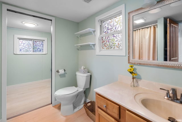 1310 Oak Ave, Lafayette, IN 47905 - full bath with toilet, vanity, wood finished floors, baseboards, and a shower with curtain