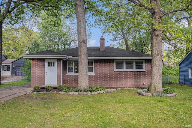 930 Oak Ridge Dr, South Bend, IN 46617 - view of front facade with brick siding, a chimney, a front lawn, roof with shingles, and a garage