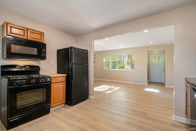 930 Oak Ridge Dr, South Bend, IN 46617 - kitchen featuring black appliances, light wood-style floors, baseboards, brown cabinets, and recessed lighting