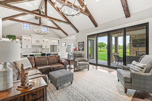 5847 Augusta Blvd, West Lafayette, IN 47906 - living area with a chandelier, light wood-style flooring, high vaulted ceiling, a fireplace, and wood ceiling with exposed beams