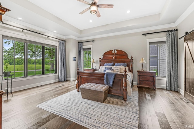 5847 Augusta Blvd, West Lafayette, IN 47906 - bedroom with a barn door, baseboards, a raised ceiling, hardwood / wood-style floors, and recessed lighting