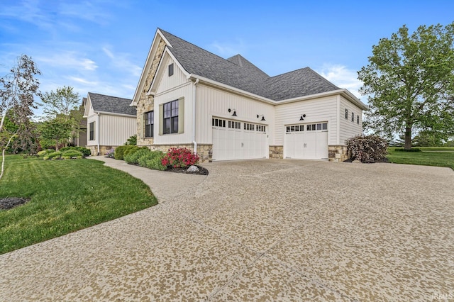 5847 Augusta Blvd, West Lafayette, IN 47906 - view of property exterior with stone siding, driveway, a garage, and a yard