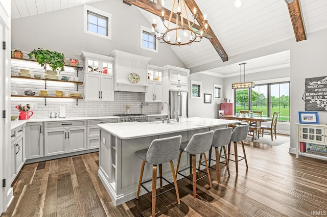 5847 Augusta Blvd, West Lafayette, IN 47906 - kitchen with high end fridge, light countertops, a chandelier, a breakfast bar, and an island with sink