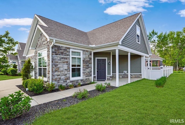 1632 Solemar Dr, West Lafayette, IN 47906 - view of front facade with stone siding, a front yard, and roof with shingles
