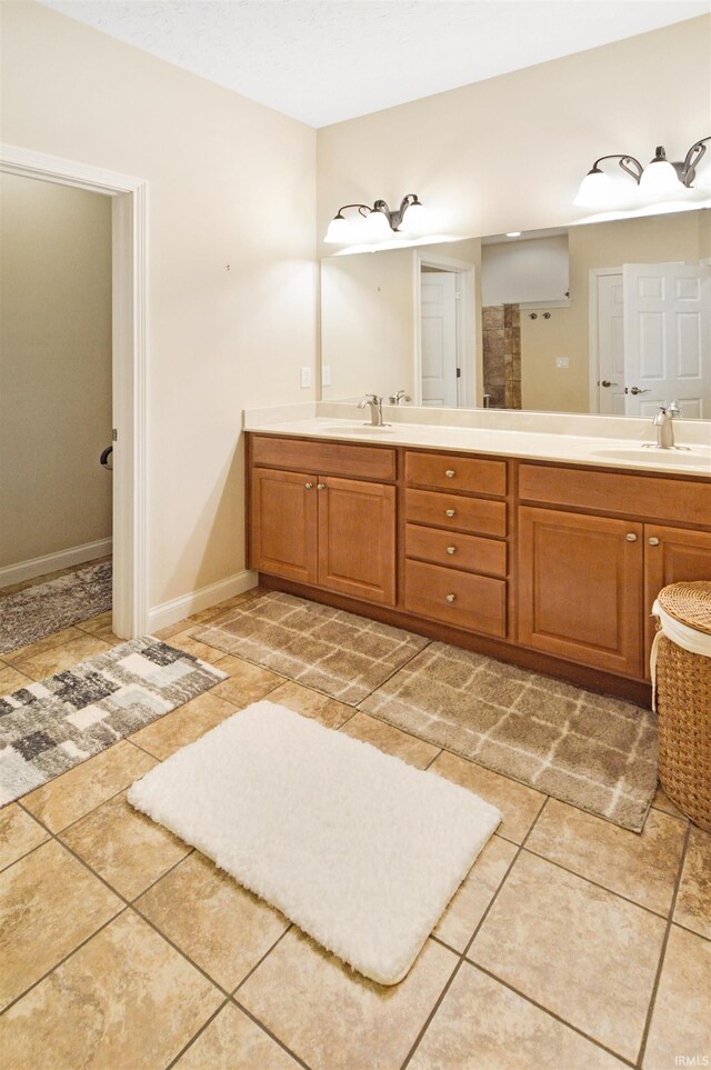 1632 Solemar Dr, West Lafayette, IN 47906 - bathroom featuring double vanity, baseboards, and tile patterned floors
