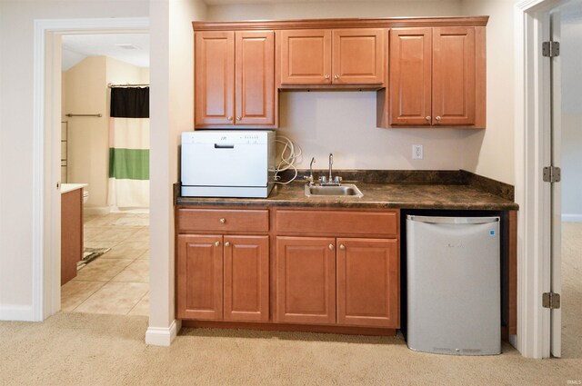 1632 Solemar Dr, West Lafayette, IN 47906 - kitchen with a sink, dark countertops, light colored carpet, dishwasher, and baseboards