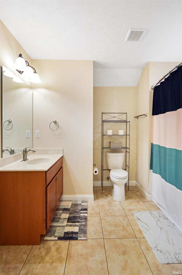 1632 Solemar Dr, West Lafayette, IN 47906 - bathroom featuring toilet, vanity, tile patterned flooring, and baseboards