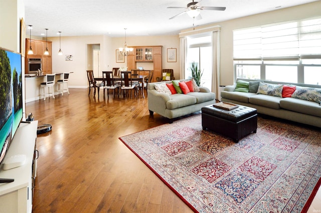 1632 Solemar Dr, West Lafayette, IN 47906 - living room featuring wood finished floors, a ceiling fan, a chandelier, and baseboards