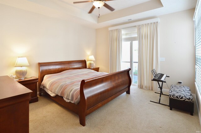 1632 Solemar Dr, West Lafayette, IN 47906 - bedroom featuring light carpet, a tray ceiling, a ceiling fan, and access to exterior