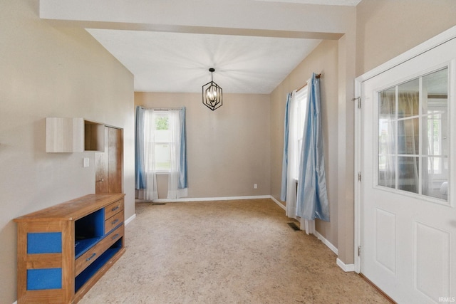2000 Vinton St, Lafayette, IN 47904 - unfurnished dining area with baseboards, light carpet, and a chandelier