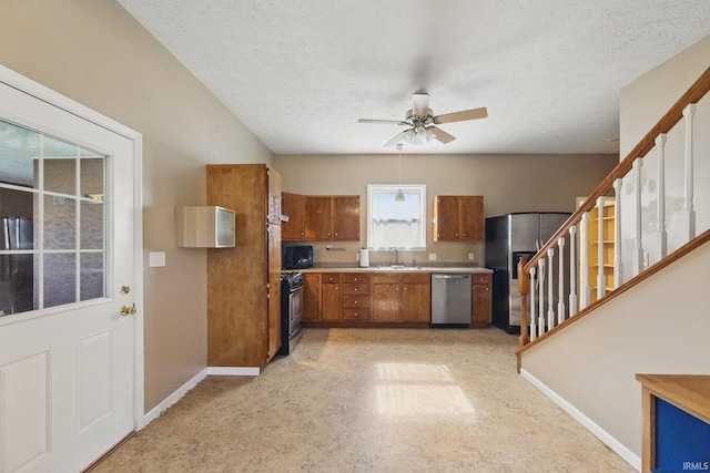 2000 Vinton St, Lafayette, IN 47904 - kitchen featuring stainless steel appliances, a sink, brown cabinets, a ceiling fan, and baseboards