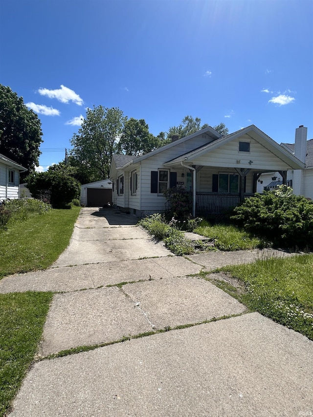 839 E 5th St, Mishawaka, IN 46544 - bungalow-style house featuring a porch and a detached garage