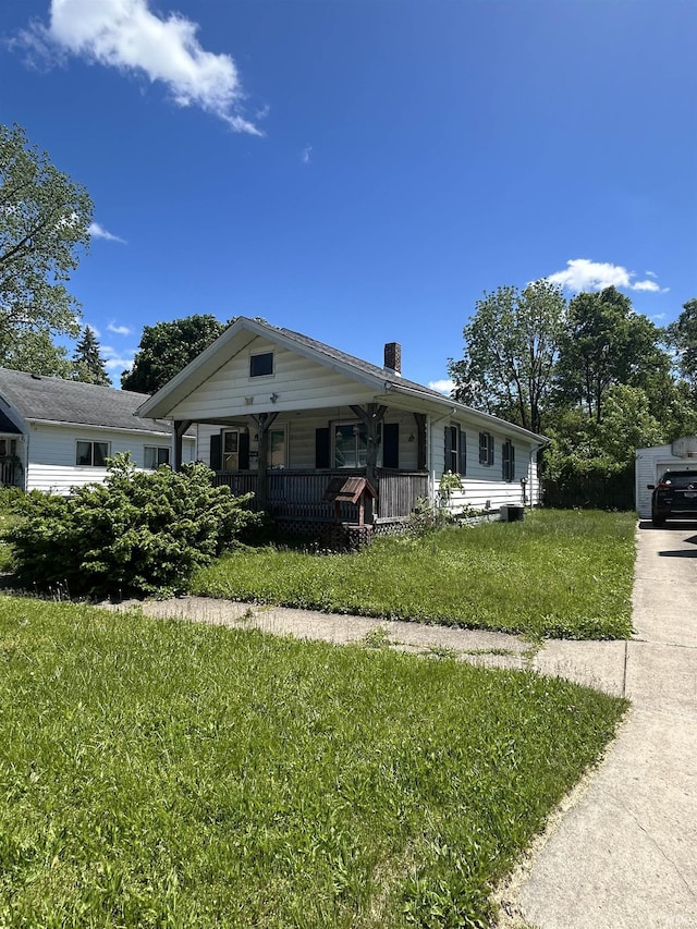839 E 5th St, Mishawaka, IN 46544 - view of front of property featuring a porch, a chimney, and a front yard
