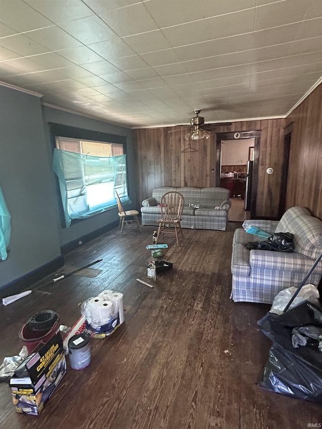 839 E 5th St, Mishawaka, IN 46544 - living area with dark wood-style flooring, wood walls, crown molding, and ceiling fan