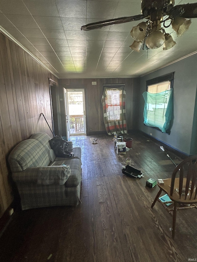 839 E 5th St, Mishawaka, IN 46544 - living room with wood-type flooring, wooden walls, ceiling fan, and baseboards