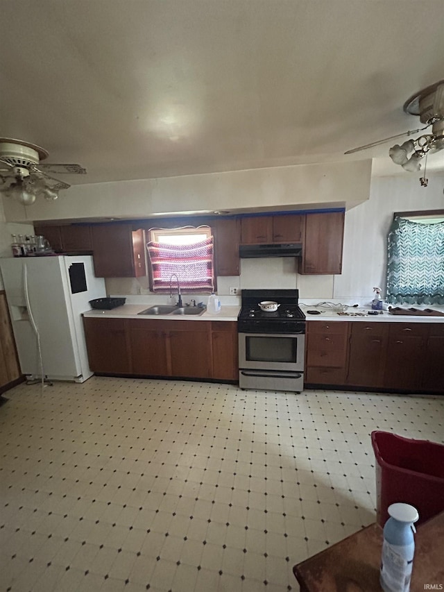 839 E 5th St, Mishawaka, IN 46544 - kitchen with a sink, gas stove, white refrigerator with ice dispenser, light countertops, and under cabinet range hood