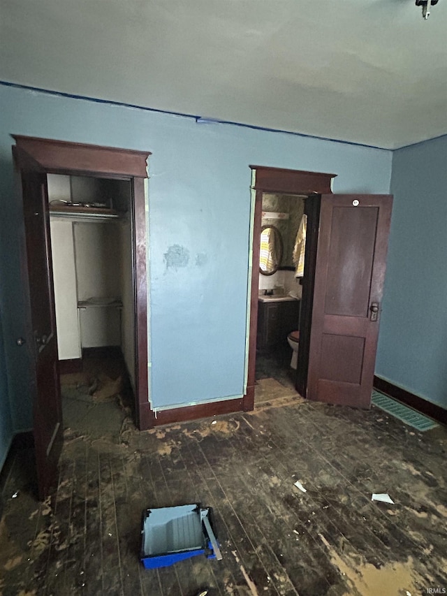 839 E 5th St, Mishawaka, IN 46544 - unfurnished bedroom featuring wood-type flooring and baseboards