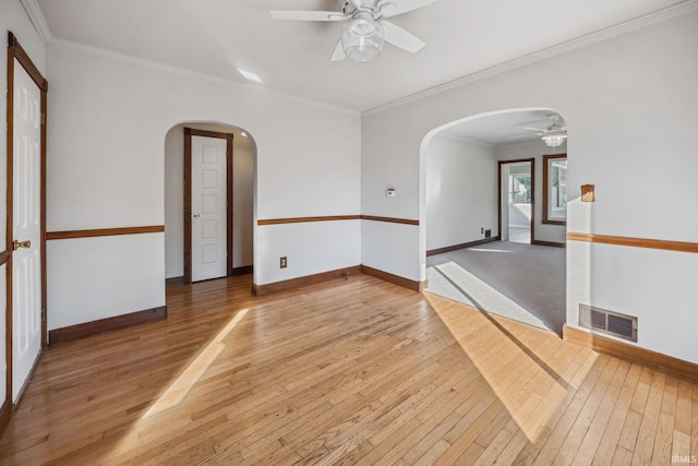 2509 Main St, Lafayette, IN 47904 - empty room featuring ceiling fan, arched walkways, light wood-style flooring, baseboards, and crown molding
