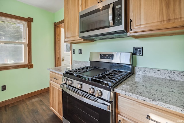2509 Main St, Lafayette, IN 47904 - kitchen with stainless steel appliances, dark wood-style floors, light stone countertops, baseboards, and light brown cabinetry