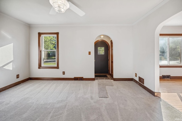 2509 Main St, Lafayette, IN 47904 - entrance foyer featuring arched walkways, carpet, crown molding, a ceiling fan, and baseboards