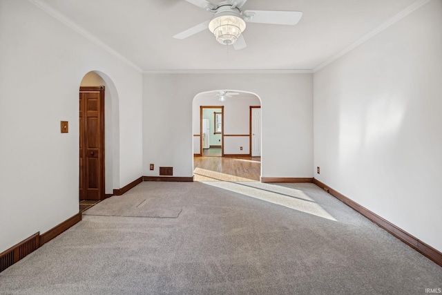 2509 Main St, Lafayette, IN 47904 - unfurnished room with a ceiling fan, arched walkways, carpet floors, crown molding, and baseboards