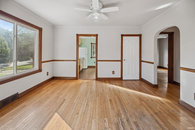 2509 Main St, Lafayette, IN 47904 - unfurnished room featuring light wood finished floors, arched walkways, a ceiling fan, ornamental molding, and baseboards